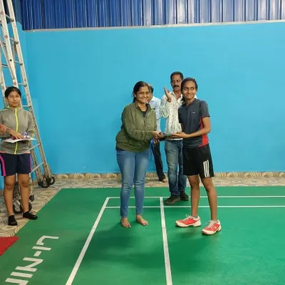 Presenting the trophy to the winner of our women's singles category during the intra-JP badminton tournament.