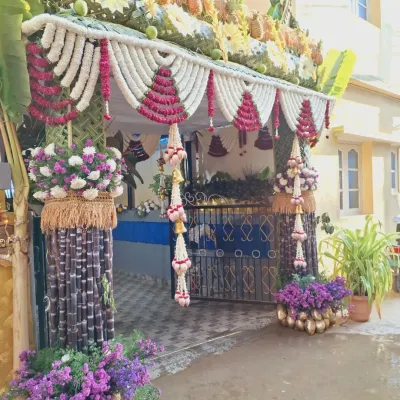 A complete view of a traditional house entrance decoration. I used sugarcane pillars, jasmine garlands, coconut leaf weaving, and even fresh pineapples to create a welcoming and auspicious entryway for the ceremony.