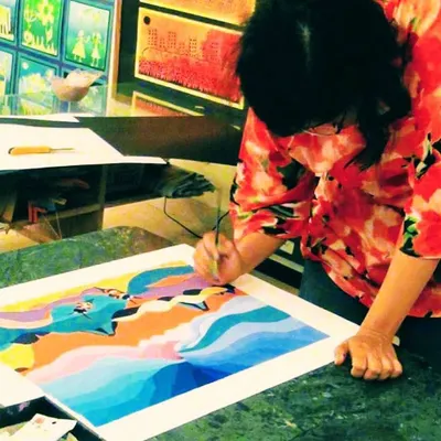 An adult student finds her flow, carefully adding details to a colorful landscape painting. My classes provide a tranquil space for you to unwind and focus on your art.