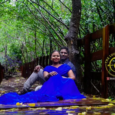 A serene maternity shoot on a wooden bridge, featuring a simple yet elegant blue gown.