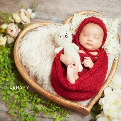 A perfect little newborn nestled in a heart-shaped basket. I use cozy wraps and props like this to ensure your baby is safe, comfortable, and looks absolutely adorable.