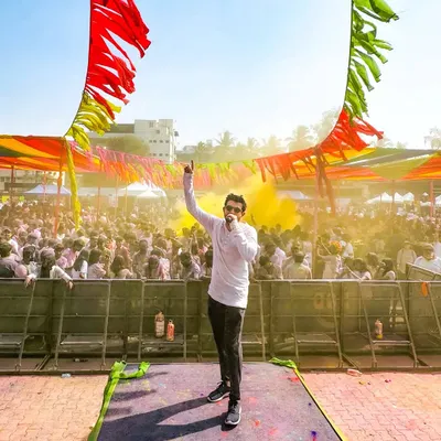 On stage at the Rang Leela Holi festival, getting the party started under the bright sun. The energy at these daytime events is amazing.
