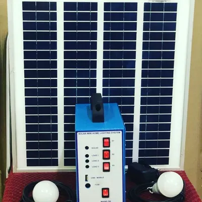 Our complete Solar Mini Home Lighting System, displayed with its solar panel, power unit, and two LED bulbs. This plug-and-play kit is an easy and affordable way to get light and phone charging capabilities anywhere.