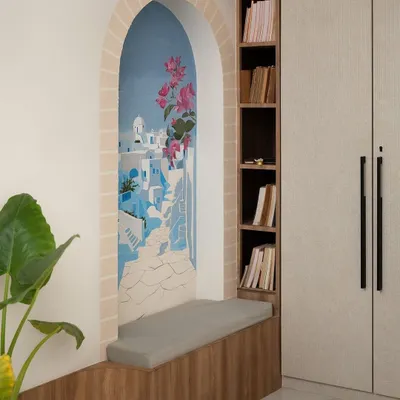 The completed Santorini mural, nestled in an arched nook with a cozy reading bench. It's a perfect example of how a mural can create a functional and imaginative feature in a room.