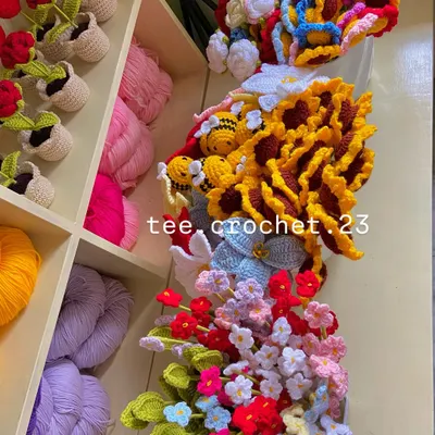 A beautiful mess of color! A collection of various flower stems and amigurumi overflowing from my shelves.