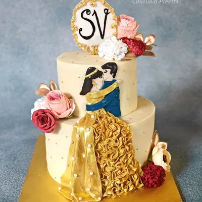 This two-tier engagement cake features a hand-painted couple figurine with a beautiful ruffled gold dress. It's a romantic centerpiece, perfect for celebrating your love story.