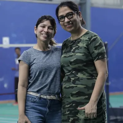 Two colleagues enjoying the event. The badminton court is a great equalizer, a place where team members can connect and build friendships outside of meetings and deadlines.