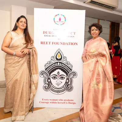 Standing beside the banner for Project 'Durga', an initiative by my Reet Foundation. The tagline says it all: "Every woman who awakens courage within herself is Durga."