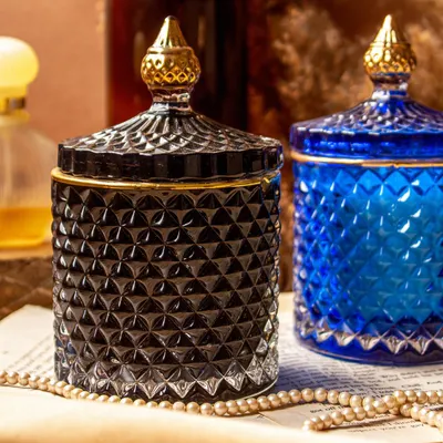 My golden line crystal jar soy candles are designed to add a touch of luxury to your home. This shot shows the elegant black and royal blue jars, which can be filled with any custom fragrance you choose, from cozy Oud to fresh Lily Rose.