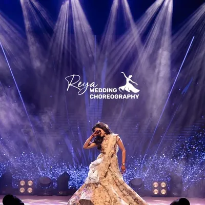 Posture and Grace. A bride's solo is her moment to shine, and this shot captures that perfectly. The dramatic lighting and her elegant pose create a powerful and timeless image.
