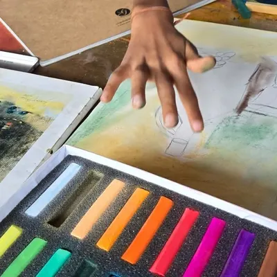 A student gets hands-on experience with dry pastels, learning to blend colors and create soft, vibrant textures. Our classes provide all the necessary materials to explore this rich and colorful medium.