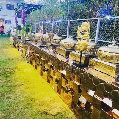 This is an example of my fully decorated, premium buffet line for an outdoor corporate event. The golden, textured counter and elegant serveware create a royal touch that elevates the entire dining experience.