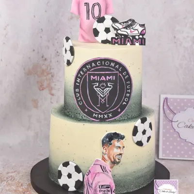 A two-tier cake for a Messi fan, celebrating his time with Inter Miami. I love painting, so I chose to hand-paint his portrait and the team logo rather than using prints.