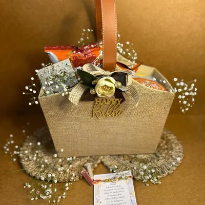 Kickstart your Rakhi celebrations with a hamper that glows with love. This jute basket is filled with treats and comes with a beautiful Rakhi, making it the perfect way to show your brother he deserves some magic.