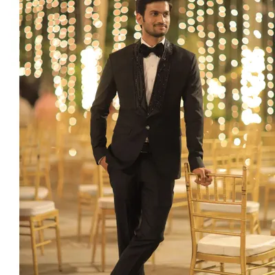 This is a custom black tuxedo I designed for a formal evening reception. The highlight is the shawl lapel, which I embellished with symmetrical black bead embroidery to add texture and a touch of opulence.