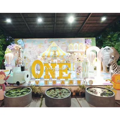 This pastel carnival party for Vihaan's first birthday was a dream to create. The main stage featured a large 'ONE' sign, a carousel, and friendly circus animal props, all in a soft, beautiful color palette.