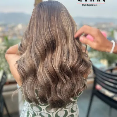 This beautiful ash-blonde balayage was created with a seamless blend of cool tones. The soft waves catch the light perfectly, showing off the different dimensions in the color.