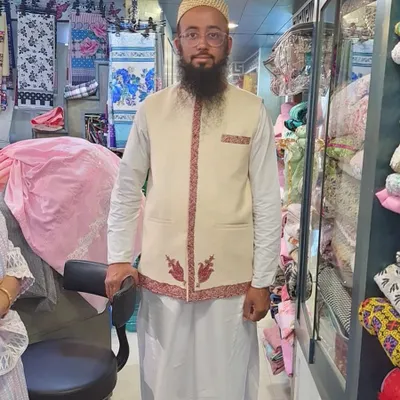 Here I am wearing a Koti made from a classic cream-colored shawl. Notice how the original border embroidery is repurposed along the front opening and pockets, giving the piece a clean, distinguished look.