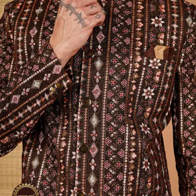 A groom's royal look starts with the details. This close-up of a brown sherwani showcases the impeccable embroidery and sequin work that defines my craft.