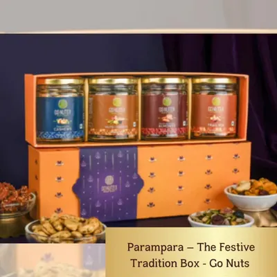 The 'Parampara' Festive Tradition Box is a perfect wedding gift that honors tradition. It contains four jars of premium assorted nuts and dried fruits in a beautiful orange and purple box.