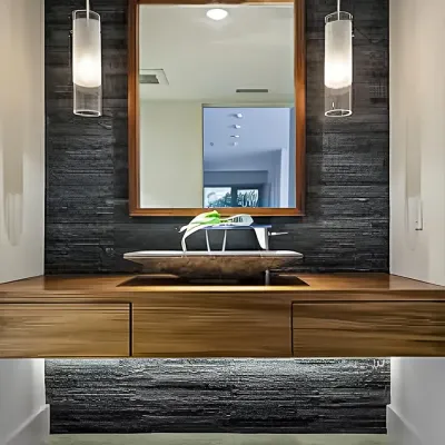 A rustic-modern powder room featuring a floating wooden vanity, a unique vessel sink, and a stacked slate accent wall. Pendant lights and under-vanity lighting create a warm and inviting glow.