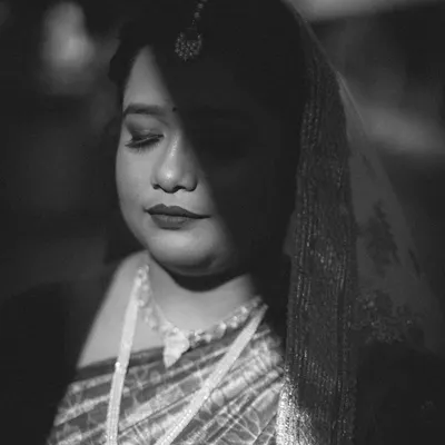 A dramatic black and white portrait of our beautiful Odia bride, captured during her wedding to her Telugu groom. The play of shadow and light highlights her features and the quiet emotion of the day.