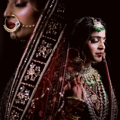 For this shot, I used a double exposure technique to blend two moments into one. It creates a dreamy, artistic portrait that highlights both the bride's serene expression and the intricate details of her wedding attire.