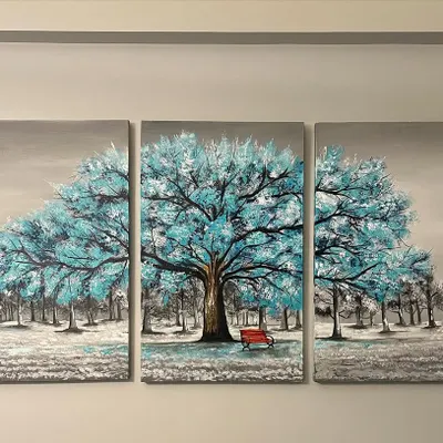 This is a three-panel canvas painting, or triptych, featuring a beautiful blue tree. It's designed to create a calm and peaceful focal point in a living room.