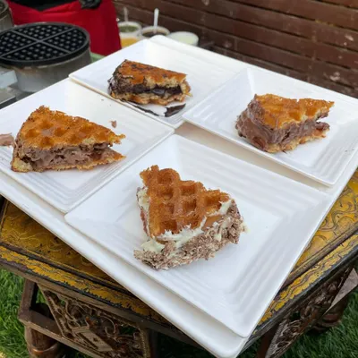A platter of our irresistible waffles, featuring different flavors and toppings. This is a perfect dessert option that appeals to guests of all ages.