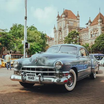 Timeless charm cruising through Bombay streets. This vintage Cadillac from 1949 looks right at home in front of the city's historic buildings.