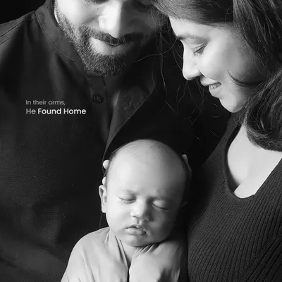 In black and white, the emotion becomes the focus. This intimate portrait captures the feeling of home, with parents gently holding their newborn, creating a powerful and timeless family heirloom.