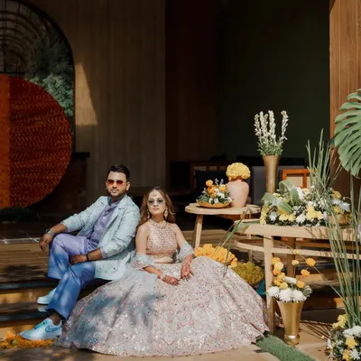 For Aashvi and Akash's Haldi Carnival, we coordinated his custom lavender kurta set with her pastel mirror-work lehenga for a look that was both playful and sophisticated.