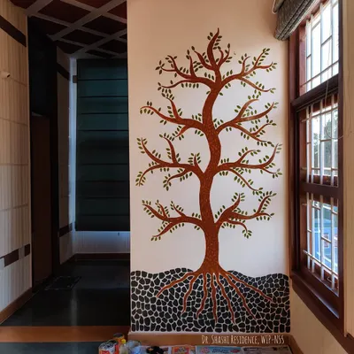 This is the 'Tree of Life' mural before the final interactive step. I painted the tree, branches, and leaves, creating a beautiful canvas ready for the kids to bring it to life.