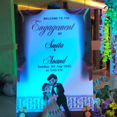 A personalized welcome sign is a great way to greet your guests. This one was designed for an engagement ceremony, featuring the couple's names, date, and a cute caricature.