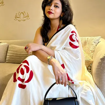 A saree date he'll never forget! This look is all about confidence, pairing a hand-painted saree with a bold red lip and a modern halter blouse for a chic and sultry vibe.