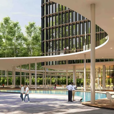 The ground level of this tech campus is designed as an inclusive community space. A large water feature and shaded walkways create a serene environment with restaurants and amenities, blurring the line between a private office campus and a public urban plaza.
