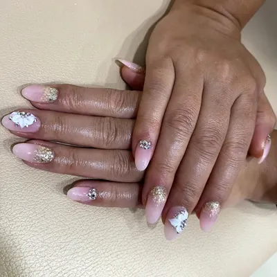 This photo shows a full set of nail extensions, demonstrating how I teach students to create both gel and acrylic nails. We compare the application process and final look of each in my classes.
