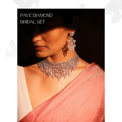 This Pave Diamond Bridal Set is the epitome of unforgettable sparkle. The necklace and matching earrings feature over 30 carats of round brilliant diamonds, meticulously set to create a cascade of light.