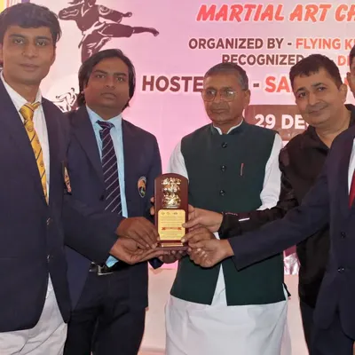 Receiving a plaque at a martial arts championship. It is an honor to be recognized by my peers and senior officials in the sports community.