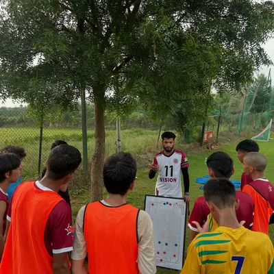 It starts with a plan. Here, I use a whiteboard to explain tactical formations and movements to the players before we head out to the pitch. Understanding the strategy is the first step to executing it.