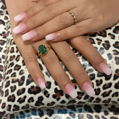 A close-up of our classic pink-to-white ombre nails on a squared coffin shape. The seamless blend and glossy top coat create a timeless and sophisticated manicure suitable for any setting.
