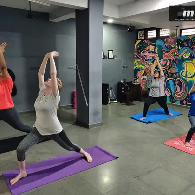 A typical group asana practice where we flow through poses like the Warrior pose. I focus on helping each student find their own expression of the posture while building strength and flexibility together as a class.