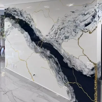 A full view of our hand-painted faux Calacatta marble wall. The dramatic black river of paint flows across the white surface, traced with fine gold veins to mimic the natural elegance of real stone.