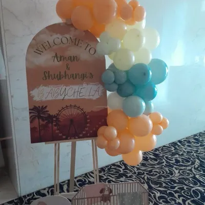 A personalized welcome sign for a "Babychella" themed baby shower. We use custom graphics and a trendy pastel balloon cluster to create a stylish and welcoming entrance for your guests.