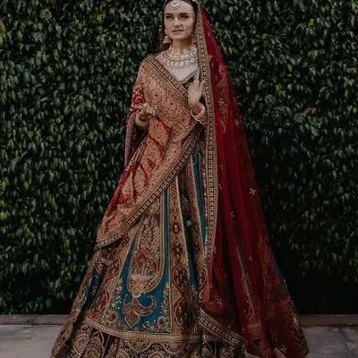 A full-length portrait showcasing Vraja's magnificent and unique bridal lehenga. I work with light and posture to create stunning images that highlight the intricate details of your attire.