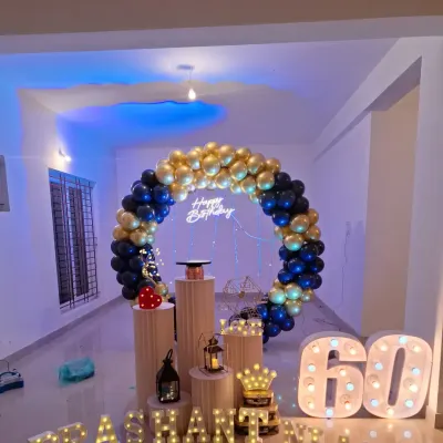 A grand celebration for a 60th birthday. I used a rich royal blue and chrome gold balloon ring, a neon sign, and large marquee numbers to create a truly memorable and elegant backdrop.