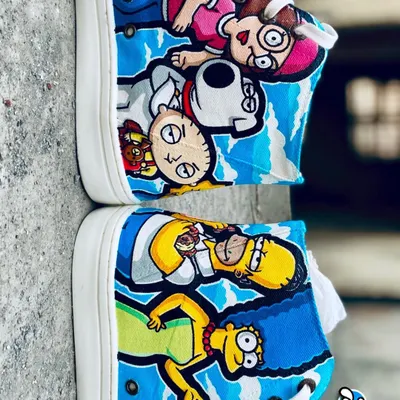 An ultimate cartoon crossover on a pair of Levi's high-tops. One shoe features Homer and Marge Simpson, while the other has the Griffin family, including Peter, Lois, Stewie, and Brian.