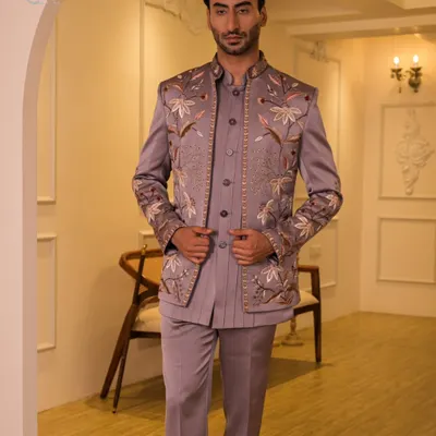 A full-length view of our mauve floral embroidered Jodhpuri suit. This three-piece ensemble includes the jacket, a matching kurta, and trousers, offering a complete, cohesive look for a groom or wedding guest.