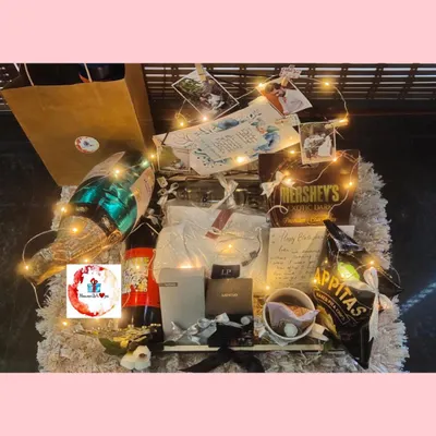 A grand hamper for the best brother. This gift is lit with fairy lights and includes a champagne bottle balloon, snacks, personalized photos, and a handwritten note.