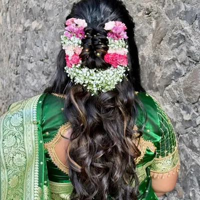 One of my favourite floral hairstyles. This half-updo is adorned with a beautiful arrangement of pink and white flowers, creating a fresh and romantic look for any bride.